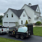 Bright Solutions ProWash truck and trailer near residential home in Hudson Valley, delivering water and equipment for professional house washing service