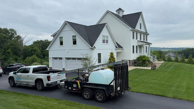 Bright Solutions ProWash truck and trailer near residential home in Hudson Valley, delivering water and equipment for professional house washing service